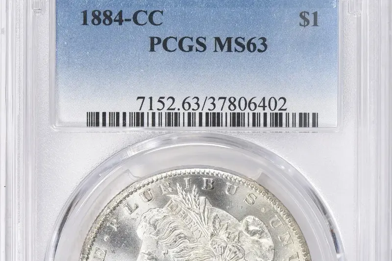 Certified coin in a graded slab — proper handling protects coin value