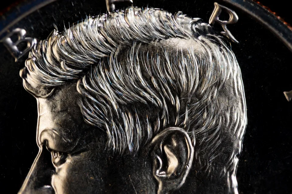 1964 Accented Hair proof Kennedy half dollar — deeply incised hair strands above Kennedy's ear, the key diagnostic of the rare early proof variety