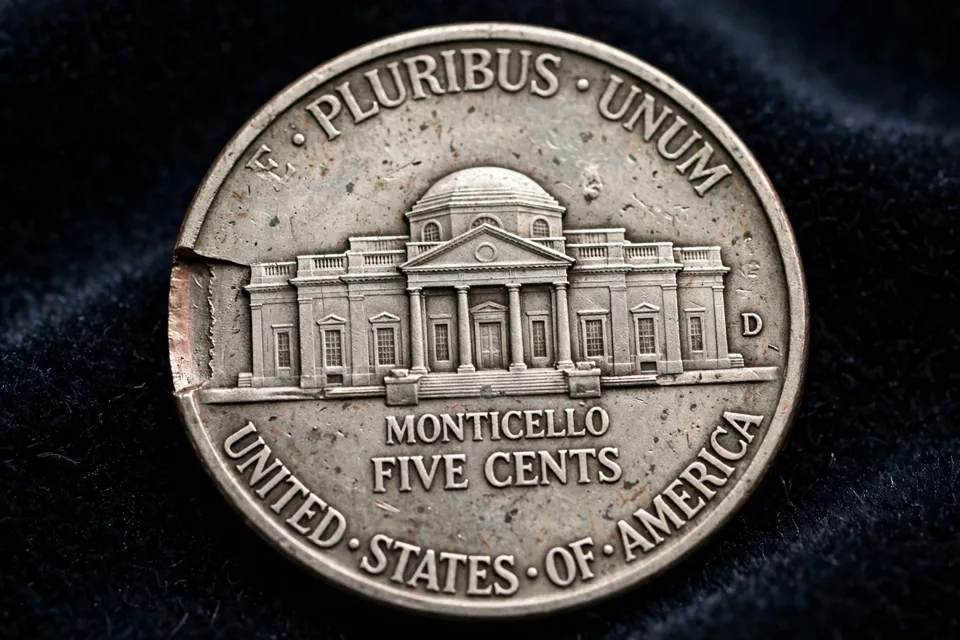 Jefferson nickel reverse with a straight clipped planchet error, a flat edge where metal is missing beside the Monticello design