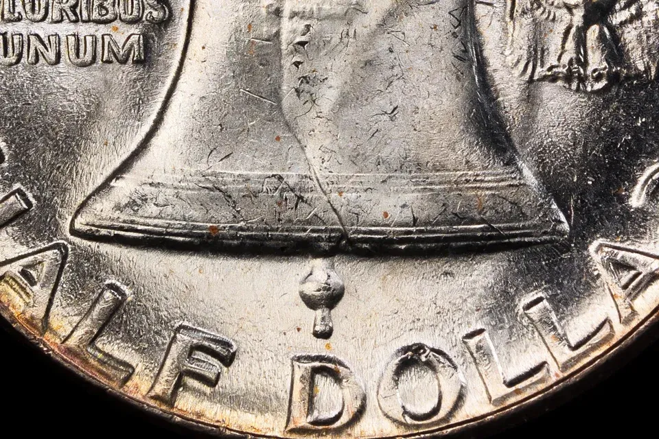 how much is a Franklin half dollar worth — extreme macro of the lower Liberty Bell showing the complete Full Bell Lines