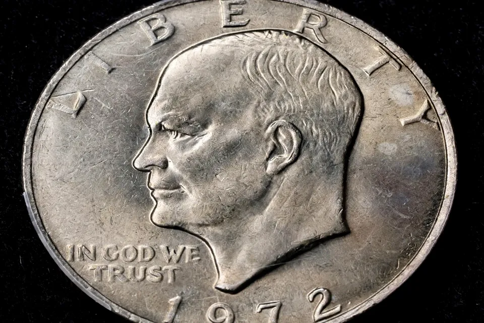Eisenhower dollar obverse close-up — 1972 portrait with LIBERTY above, IN GOD WE TRUST at lower left, and no mint mark below the neck