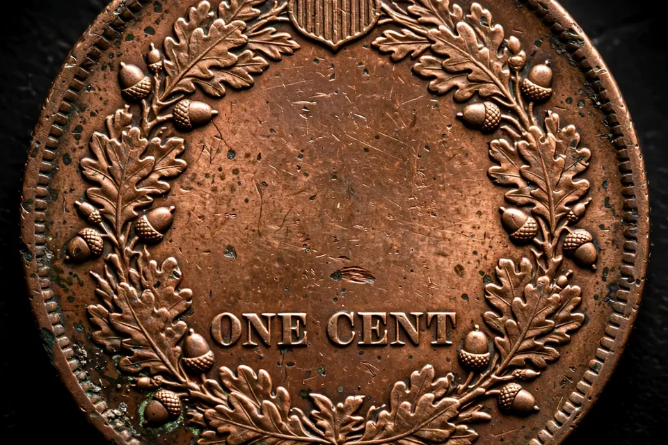 Indian Head penny reverse close-up — oak wreath with a shield at the top enclosing ONE CENT, the standard reverse from 1860 through 1909