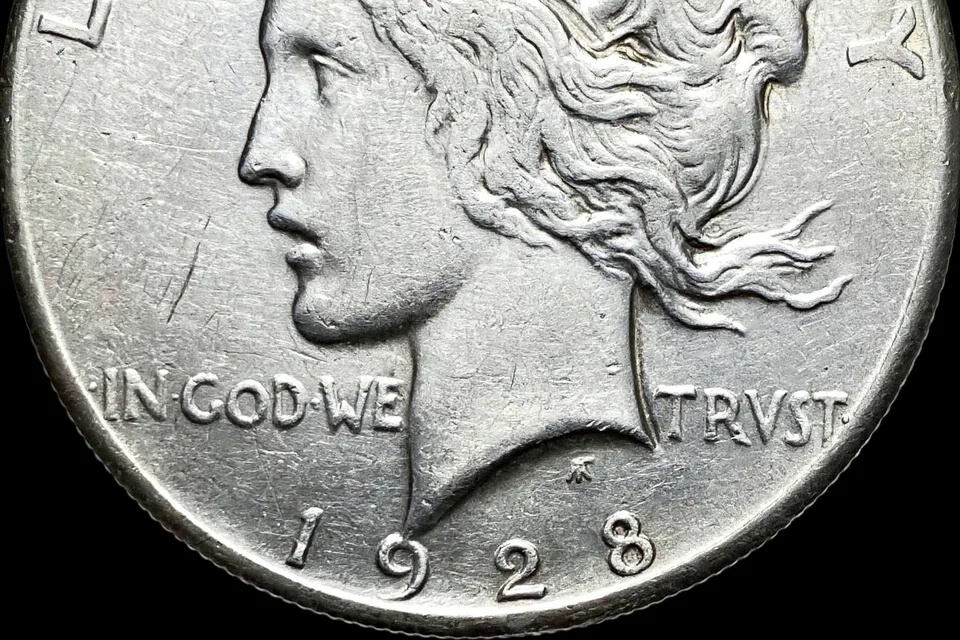 how much is a Peace dollar worth — 1928 Peace dollar date close-up showing the key-date year below Liberty